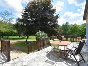 a patio with a table and chairs on a fence at Cosy holiday home in Lantheuil with garden in Villefranche-du-Périgord