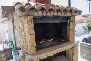 a stone fireplace with a pizza inside of it at Apartment Baćo in Split