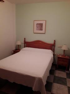 A bed or beds in a room at Hostal San Andres