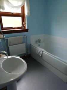 a bathroom with a sink and a bath tub and a sink at Balhousie Farm Bed and Breakfast in Kirkton of Largo