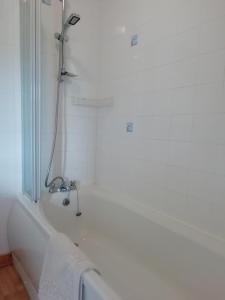 y baño blanco con ducha y bañera. en Balhousie Farm Bed and Breakfast en Kirkton of Largo