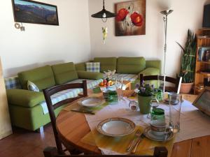 a living room with a table and a couch at Apartmenthaus Simmer in Obertraun