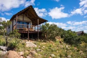 a house on a hill with a deck at Ikwanitsha Lodge in Paterson