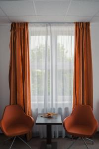 a table and two chairs in front of a window at Sport-Relax Centrum Bors Club in Břeclav