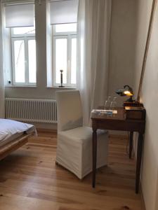 a bedroom with a desk and a chair and window at pirrung lebensräume in Sankt Ingbert