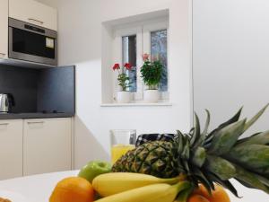 a pineapple sitting on a kitchen counter with fruits and vegetables at Studio apartment Milla in Split