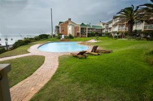 a park with benches and a pool and some houses at Brookes Hill Private Suite in Port Elizabeth
