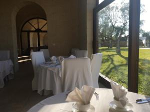 a dining room table with a white tablecloth at Masseria San Polo in Squinzano