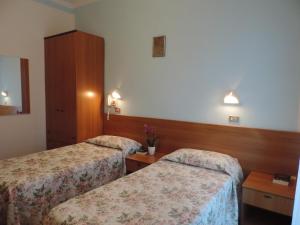 Postel nebo postele na pokoji v ubytování Hotel Liliana