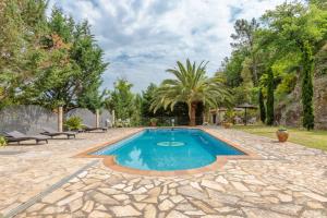 a swimming pool in a yard with a stone patio at Flateli Anglès in Anglés