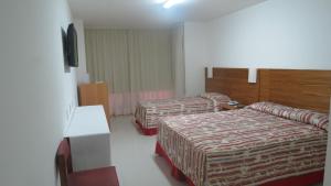 a hotel room with two beds and two lamps at Atlântico Centro Apartments in Rio de Janeiro