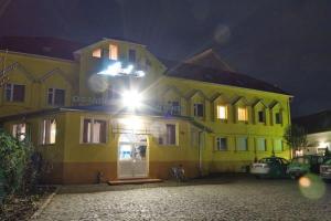 a yellow building with a light on top of it at Apollon in Mukacheve