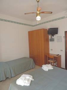 Postel nebo postele na pokoji v ubytování Hotel Liliana