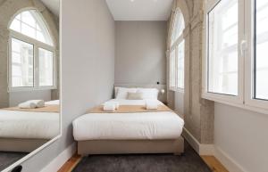 En eller flere senge i et værelse på LovelyStay - Allderman Apartment - Almada 1º T