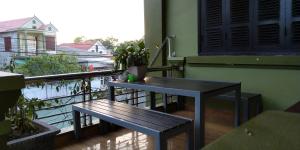 two benches on the balcony of a building at Backpackers Hotel in Hà Tĩnh