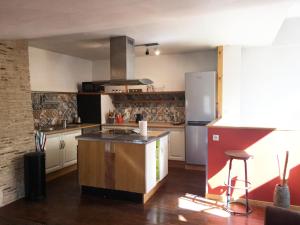 a kitchen with an island in the middle of it at Gite la Tropezienne in Blaye