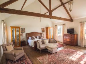 a bedroom with a bed and a couch and a chair at The Delaval Rooms in Lincoln