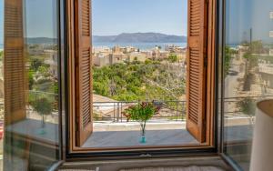 a window with a view of the city and the ocean at Holiday Home Froudaki 1 in Kissamos