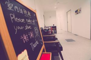 a chalk board with writing on it in a classroom at The Haven Inn in Malacca