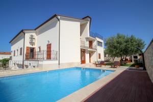 a villa with a swimming pool in front of a house at Casa Rafael in Novigrad Istria