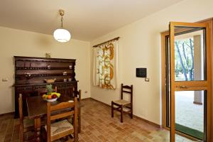 a dining room with a table and chairs and a mirror at Lido Camping Village in Bolsena