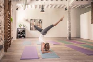 a woman doing a handstand in a yoga class at Hotel Brummell in Barcelona