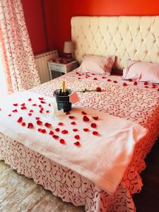 a bed with a bunch of red hearts on it at Alojamento Local S. Bartolomeu in Trancoso