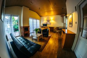 a living room with a couch and a table at Ośrodek Szkoleniowo-Wypoczynkowy "Stodoły" in Rybnik