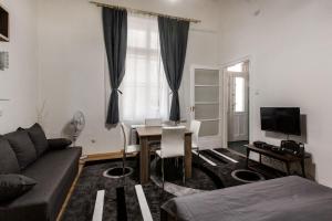 a living room with a couch and a table at W2 Synagogue Apartment in Budapest