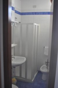 a bathroom with a sink and a toilet at Hotel Villa Candia in Lignano Sabbiadoro