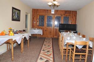 a dining room with tables and chairs with food on them at Hotel HAXHIU Tirane in Tirana