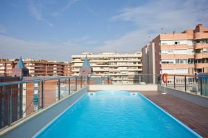 a swimming pool on the roof of a building at Ilunion Les Corts Spa in Barcelona