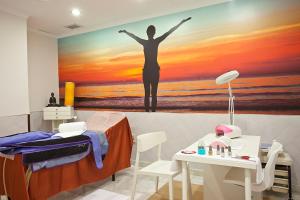 a painting of a person standing on a bed next to a painting of a at Ilunion Les Corts Spa in Barcelona