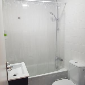 a bathroom with a toilet and a sink and a shower at Fabulous Apartaments in Lisbon