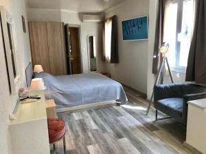 a bedroom with a bed and a living room with a couch at Sailor's Nautical Concept in Spetses