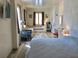 a bedroom with a bed and a living room at Sailor's Nautical Concept in Spetses