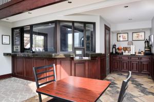 a dining room with a wooden table and a bar at Americas Best Value Inn Medical Center Downtown in Houston