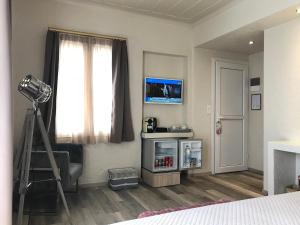 a bedroom with a camera and a window with a ladder at Sailor's Nautical Concept in Spetses