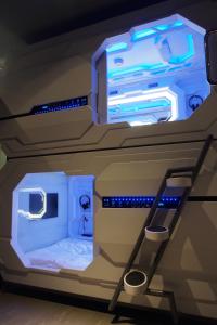 a room with a bunk bed with blue lights at Space Hotel @ Chinatown Kuala Lumpur in Kuala Lumpur