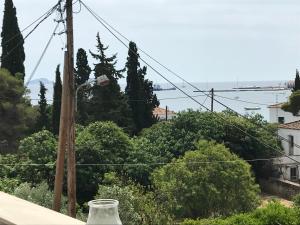 a glass vase sitting on a ledge with trees at Sailor's Nautical Concept in Spetses
