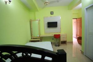 a hospital room with a bed and a tv at Little Rangpur Inn in Rangpur