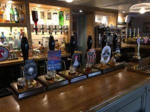 a bar with several bottles of alcohol on a counter at Fishermans Tavern in Dundee