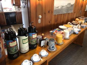 a wooden table with many bottles on top of it at The Seaside Inn in Kennebunk Beach