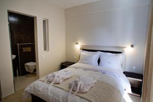 a bedroom with a bed with towels on it at Rg Status Hotel in Paralia Katerinis