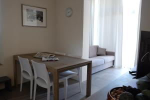 a living room with a wooden table and chairs at Acqua Dolce in Rio Marina
