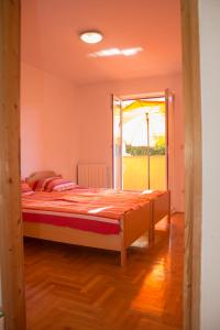 a bedroom with a large bed and a window at Malinska - Apartment Glavas in Malinska