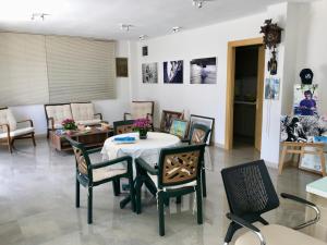 a living room with a table and chairs at EVN Hotel in Çeşme