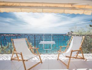 two chairs on a balcony with a view of the ocean at Apartment Stefan in Sveti Stefan