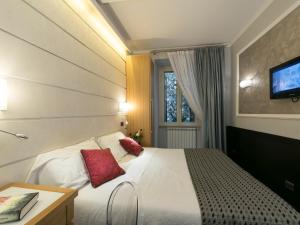 A bed or beds in a room at DK Suites