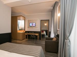 A bed or beds in a room at DK Suites